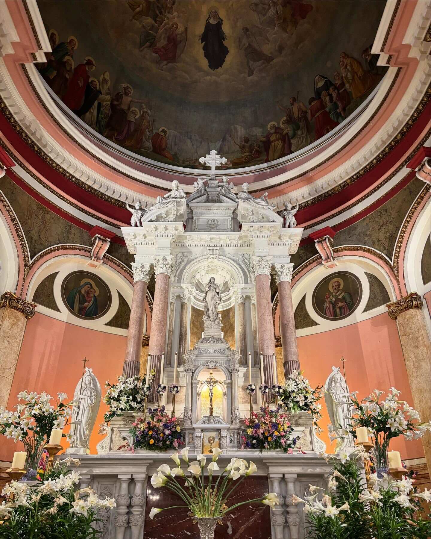 Interior of Saint Rita's shrine showing the altar and ceiling paintings